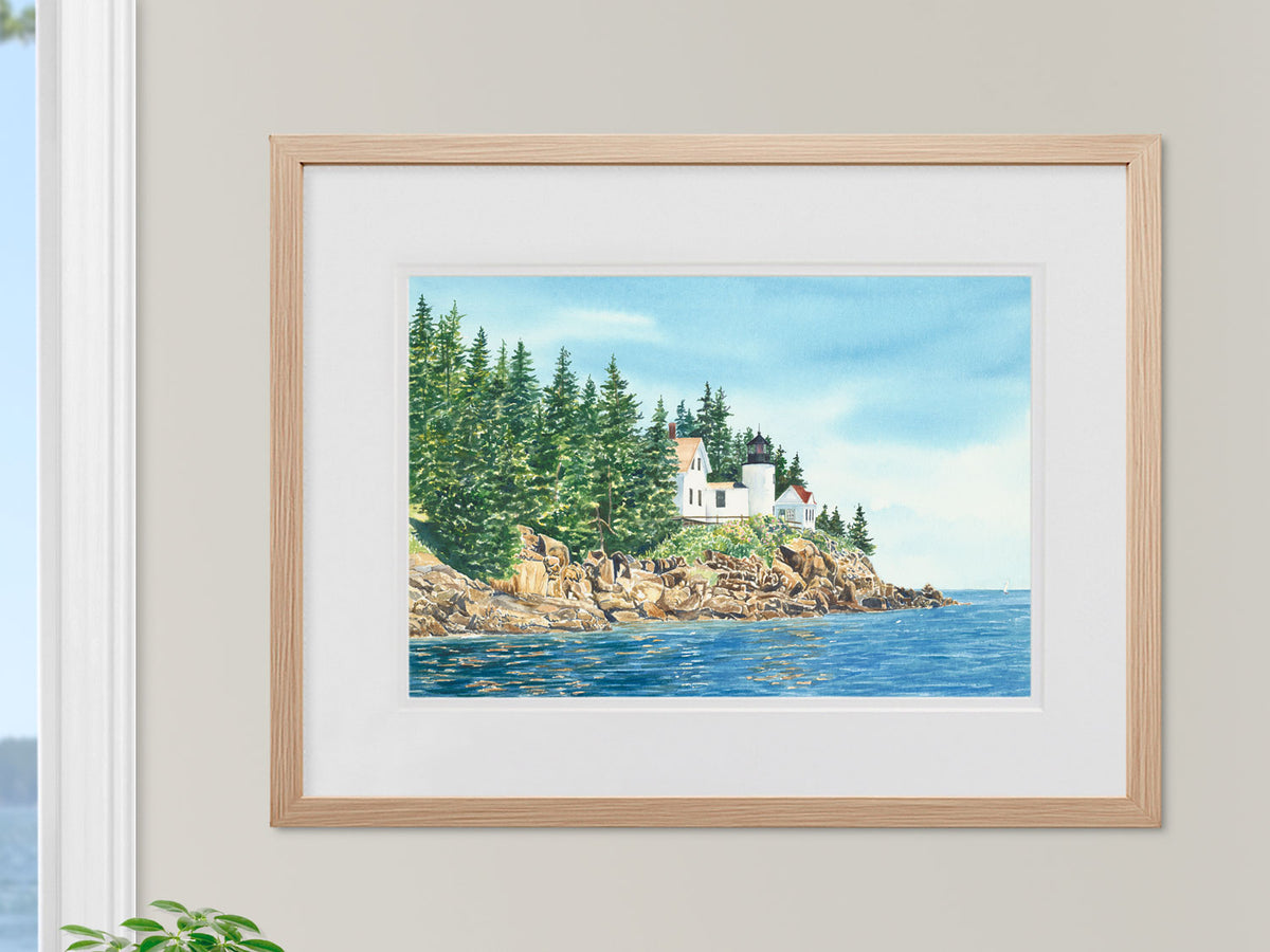 Framed original watercolor painting of Bass Harbor Light, Left view, displayed in a warm wood frame.
