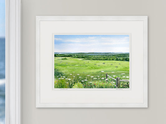 Framed watercolor print of Caterpillar Hill, Eggemoggin Reach view, in a white frame with natural window light.