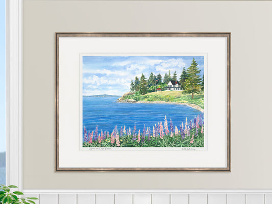 Framed watercolor print of Lupine on Cape Rosier, Penobscot Bay, in a warm wood frame in a lifestyle setting.
