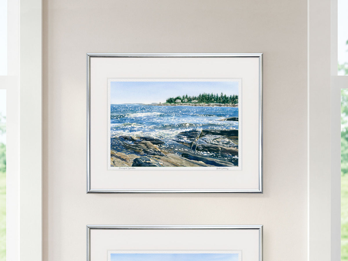 Framed watercolor print of Pemaquid Sparkles, Pemaquid Point, Maine, in a silver frame between two windows.