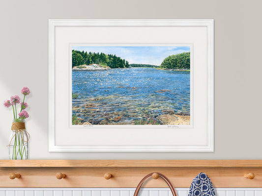 Framed watercolor print of Spirit Pond, Phippsburg, Maine, in a white frame in a kitchen decor setting.