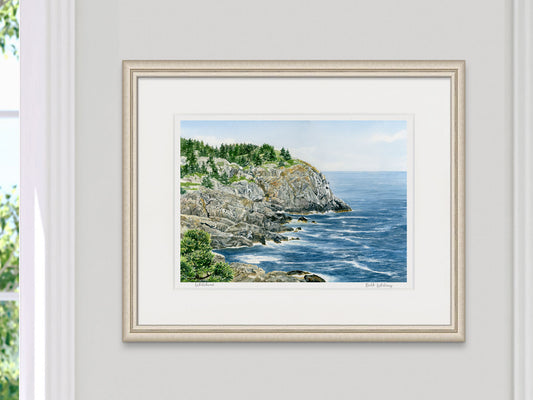 Framed watercolor print of Whitehead, Monhegan Island, Maine, in a pale gold frame beside a sunny window.