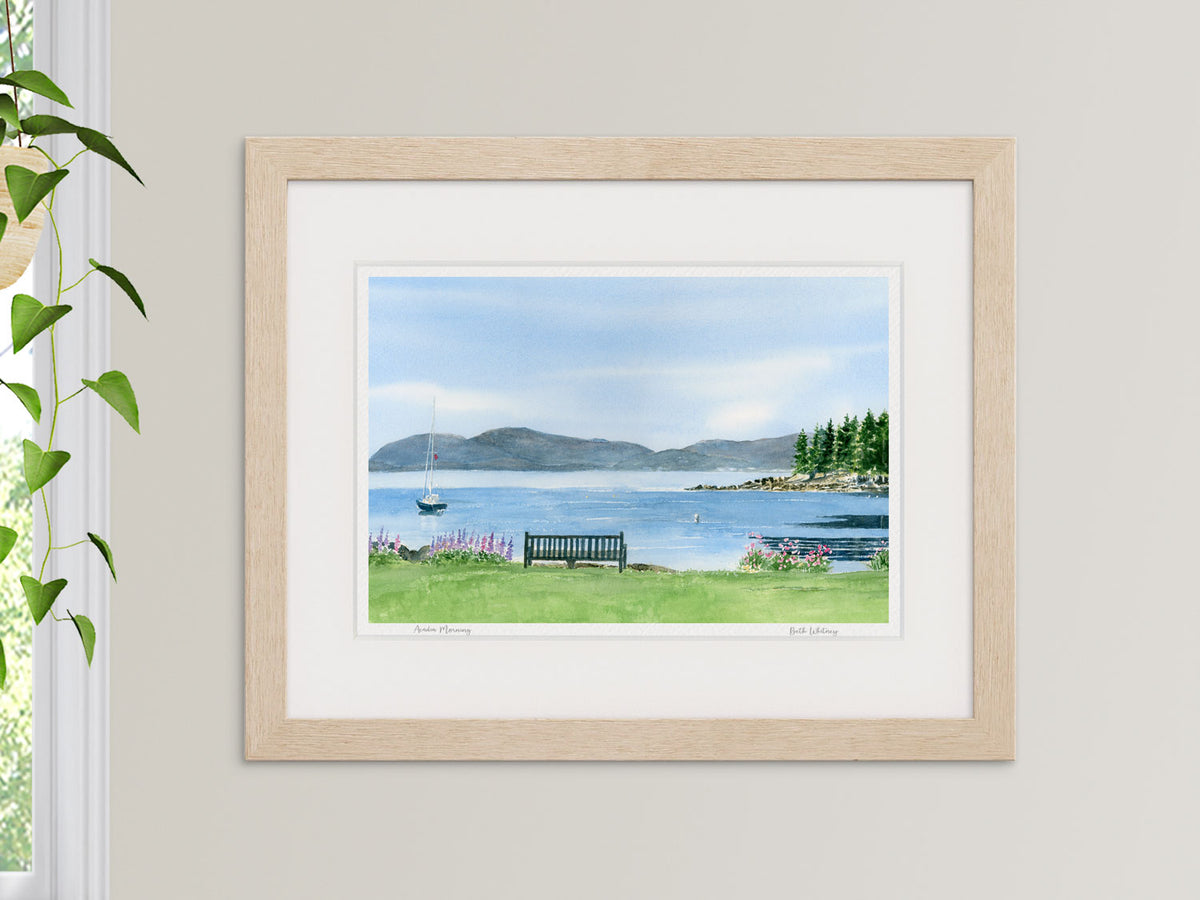 Framed watercolor print of Acadia Morning, Frenchman's Bay, styled in a bright interior setting.