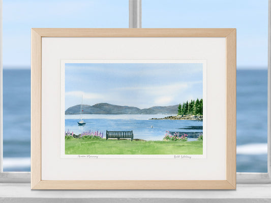 Framed watercolor print of Acadia Morning, Frenchman's Bay and Acadia mountains, displayed on a coastal wall with ocean view.