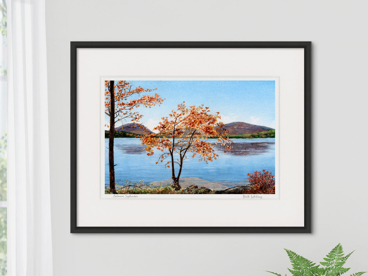 Framed watercolor print of Autumn Splendor, Eagle Lake, Acadia National Park, in a black frame on a neutral wall.