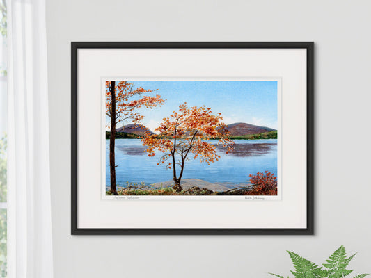 Framed watercolor print of Autumn Splendor, Eagle Lake, Acadia National Park, in a black frame on a neutral wall.