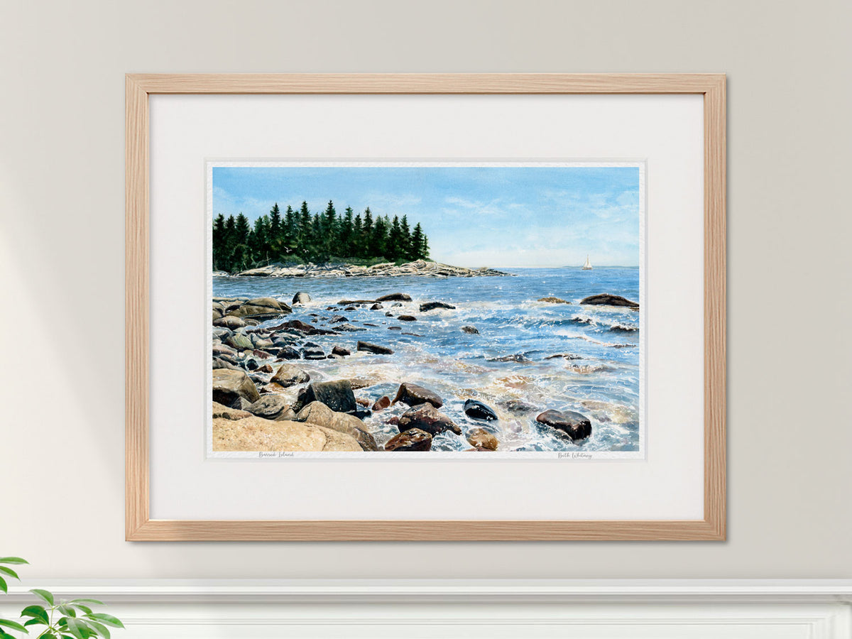 Framed watercolor print of Barred Island, East Penobscot Bay, in a warm wood frame interior setting.