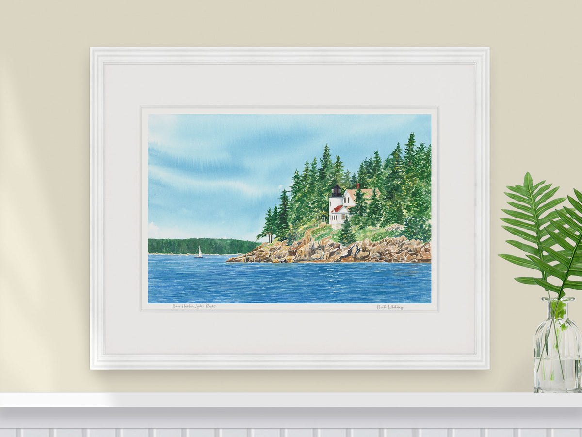 Framed watercolor print of Bass Harbor Light, Right, in a white frame with natural window light.