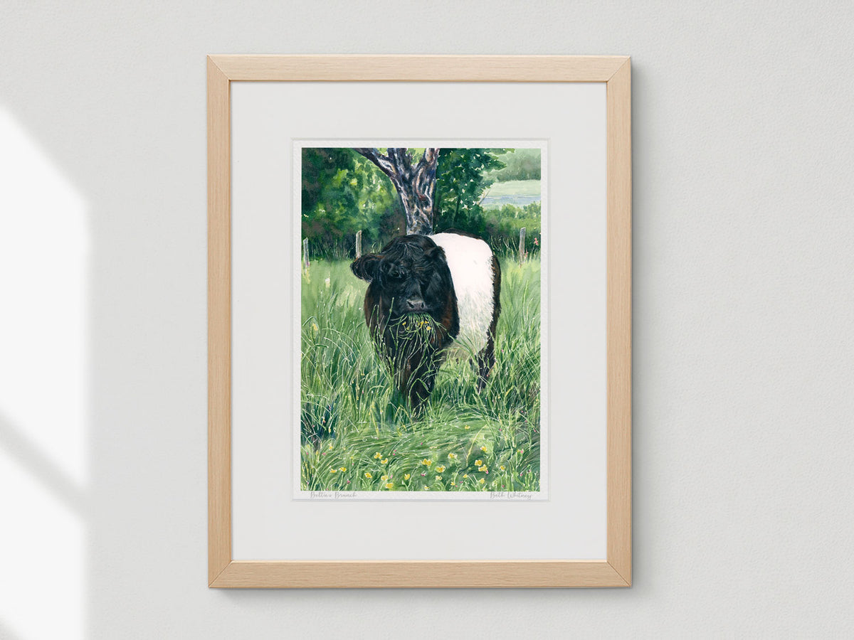 Framed watercolor print of Beltie's Brunch in a warm wood frame on a white wall.