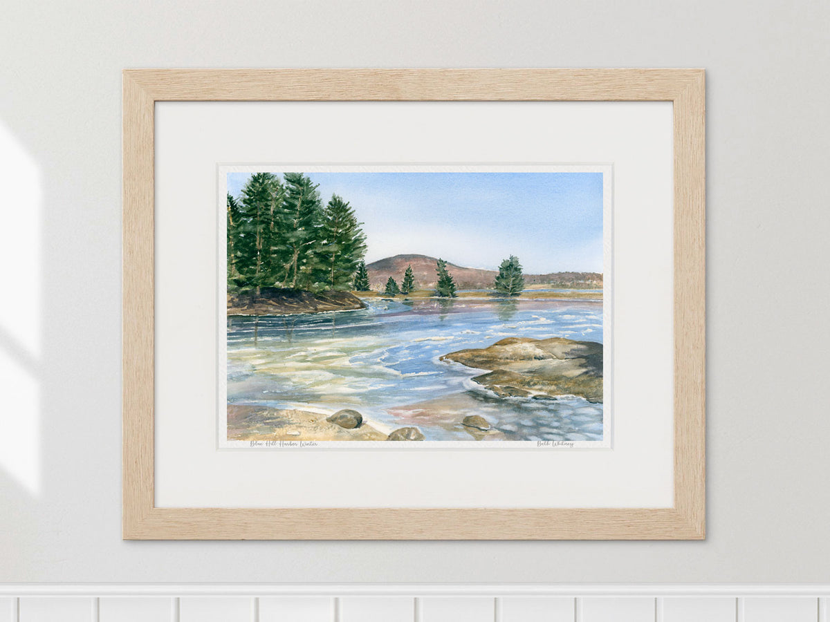 Framed watercolor print of Blue Hill Harbor Winter in a warm wood frame on a neutral wall.