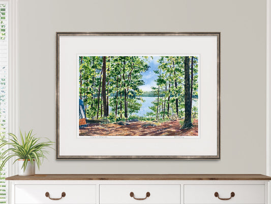 Framed watercolor print of Camping at Sebago Lake displayed above a dresser in a lifestyle setting.