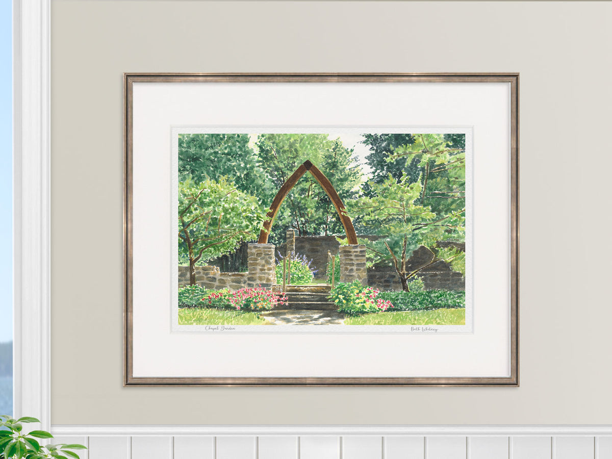 Framed watercolor print of Chapel Garden, Rockport, Maine, displayed above a dresser in a lifestyle setting.