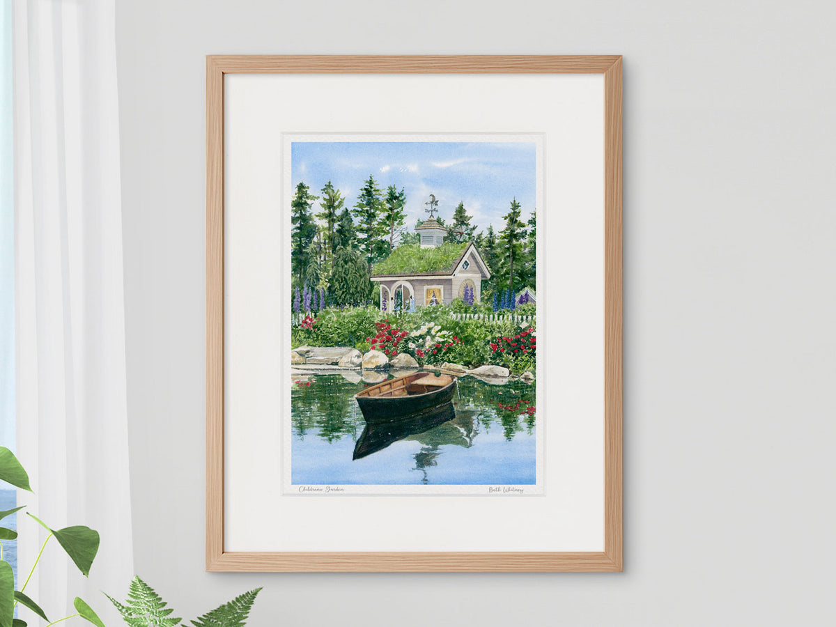 Framed watercolor print of Children's Garden, Boothbay, Maine, in a warm wood frame with plant styling.