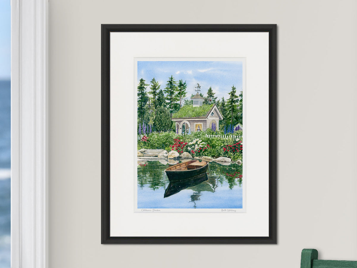Framed watercolor print of Children's Garden, Coastal Maine Botanical Gardens, in a black frame on a neutral wall.