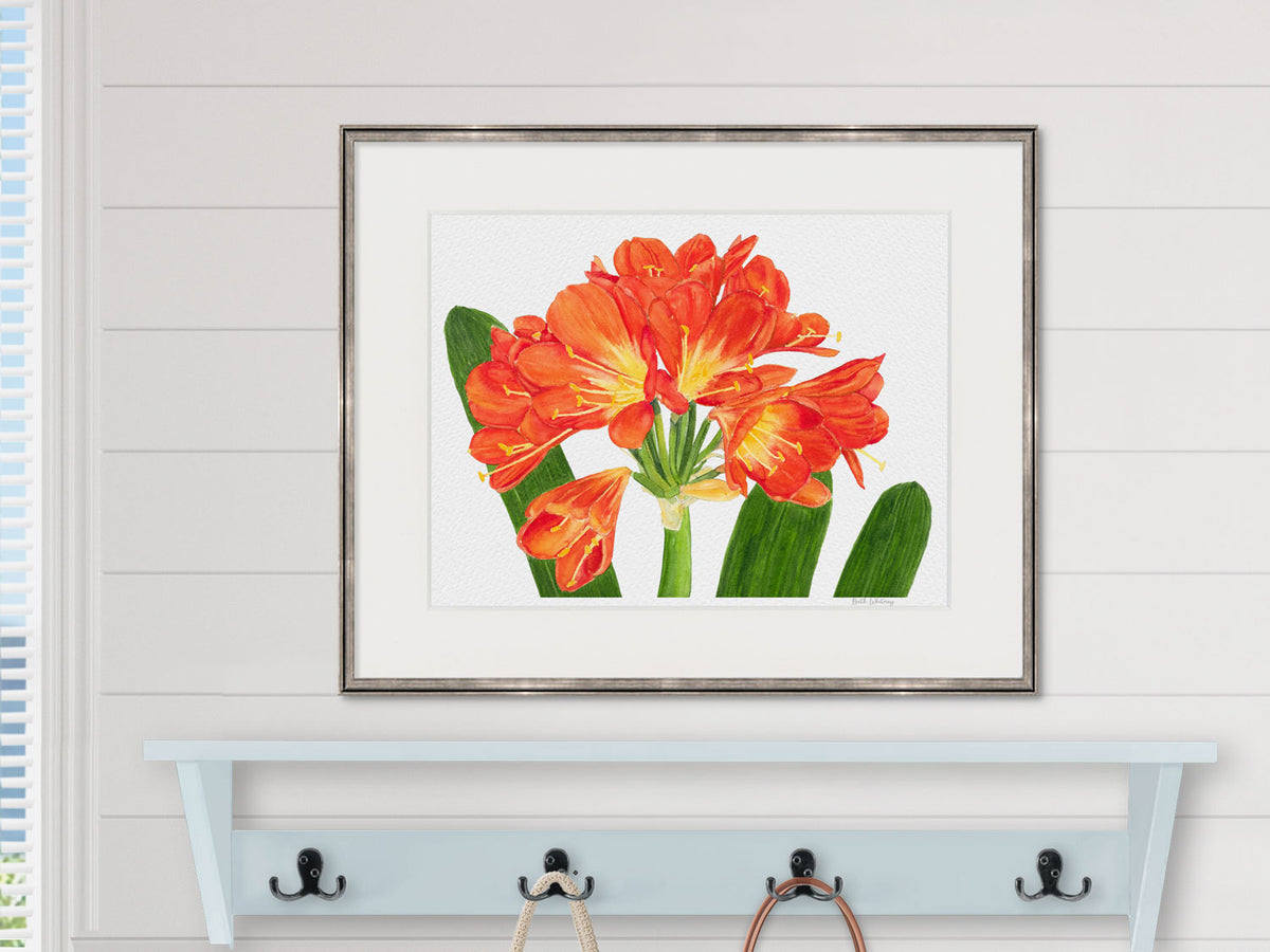 Framed watercolor print of Clivia flowers in a bathroom lifestyle setting.