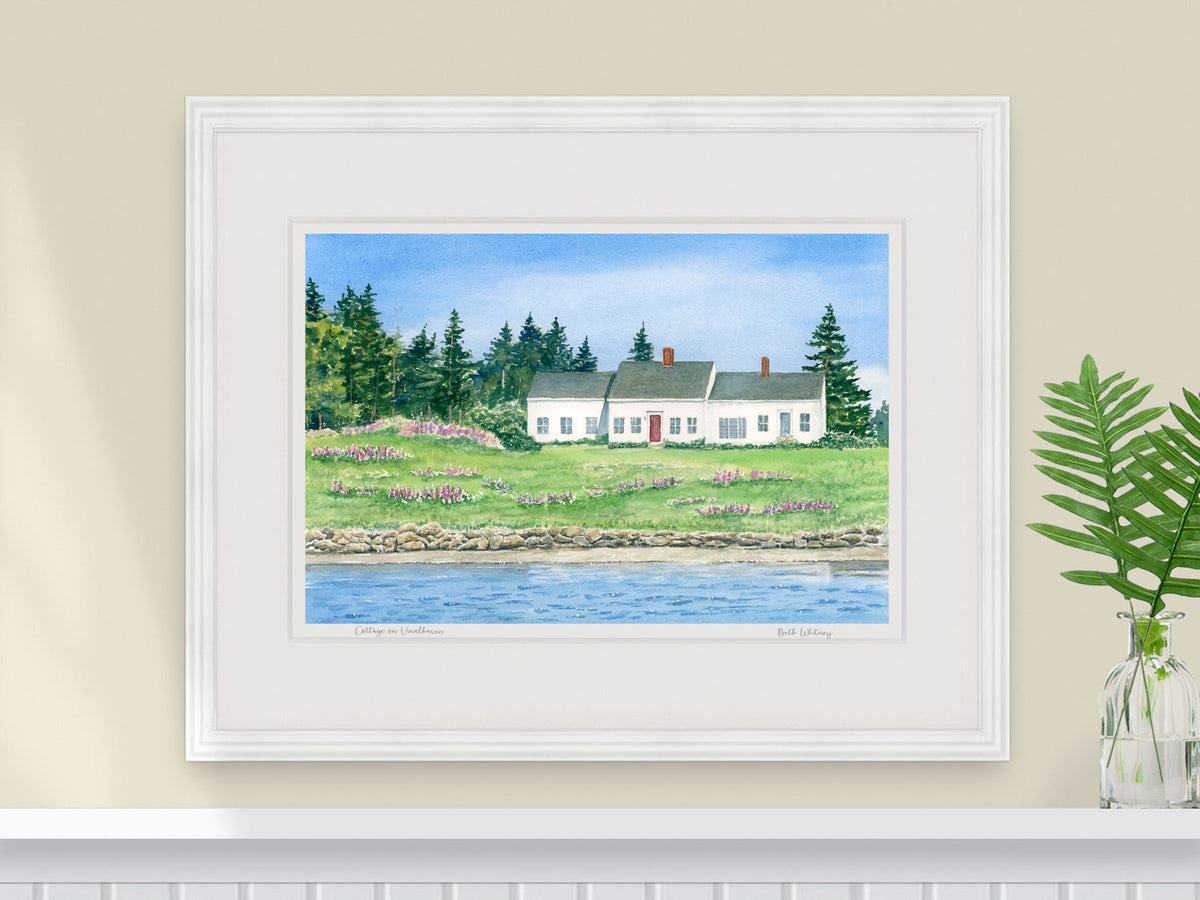 Framed watercolor print of Cottage on Vinalhaven in a warm wood frame with fern styling.