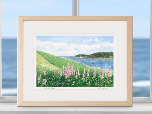 Framed watercolor print of Deer Isle Lupine in a warm wood frame with natural window light.