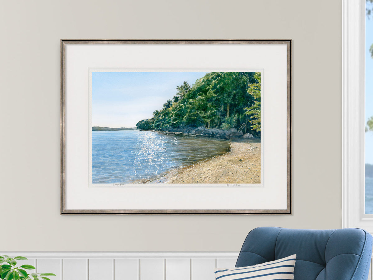 Framed watercolor print of Dodge Point Preserve, Newcastle, Maine, displayed in a bedroom lifestyle setting.
