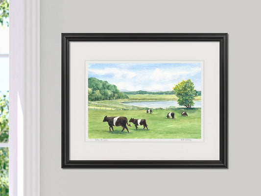 Framed watercolor print of Follow the Leader, Belted Galloway cattle, in a black frame on a neutral wall.
