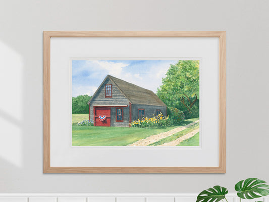 Framed original watercolor painting of Friendship Barn in a warm wood frame.