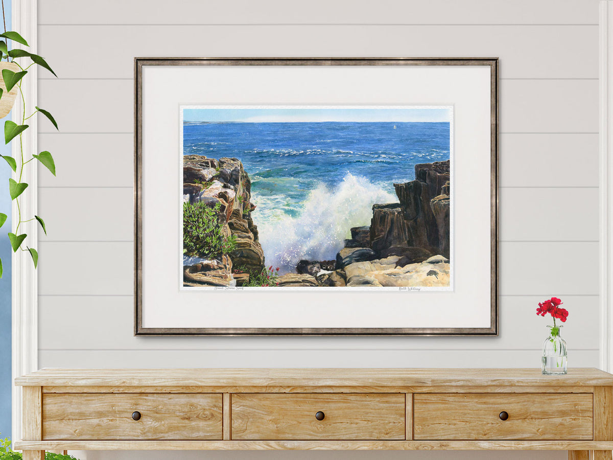 Framed watercolor print of Giant Stairs Surf in a warm wood frame in a lifestyle setting.