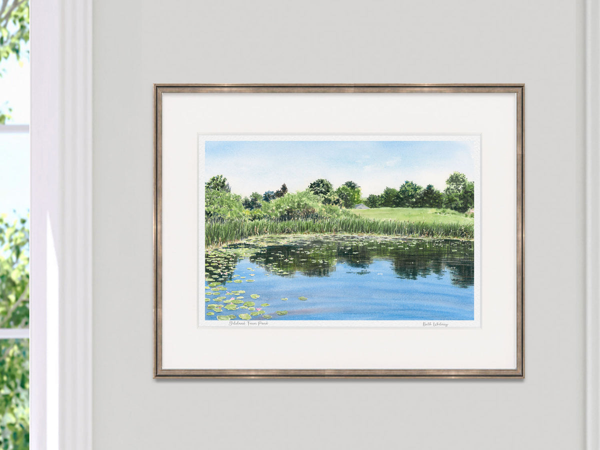 Framed watercolor print of Gilsland Farm Pond, Maine Audubon, in a copper frame on a neutral wall.