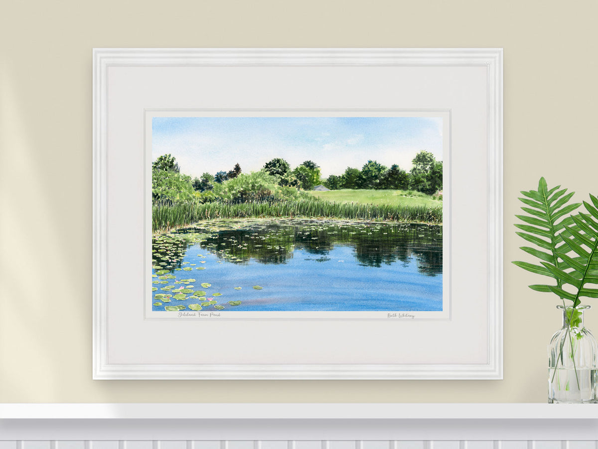 Framed watercolor print of Gilsland Farm Pond in a white frame with fern styling.