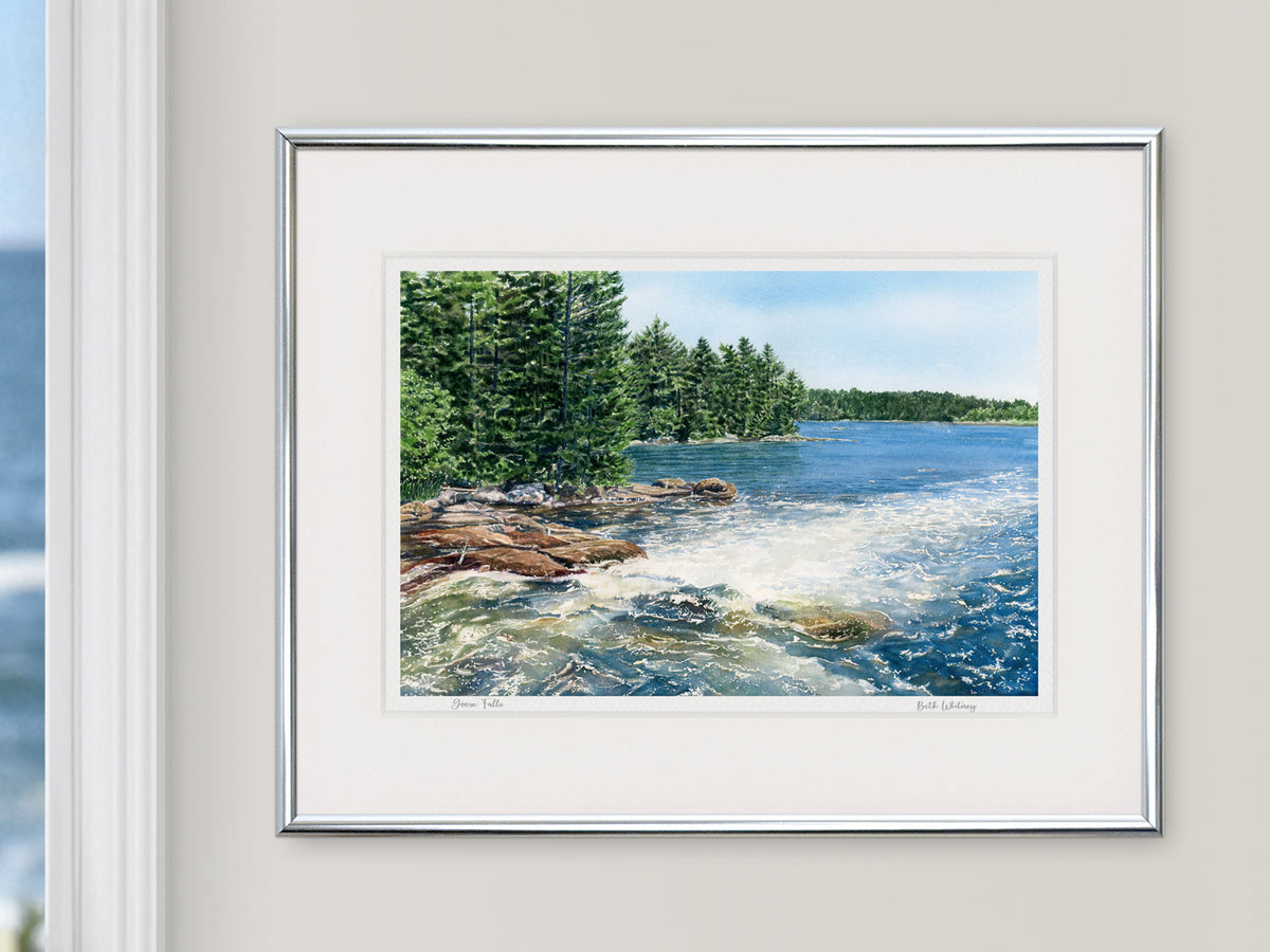 Framed watercolor print of Goose Falls, Cape Rosier, Maine, in a silver frame with natural window light.