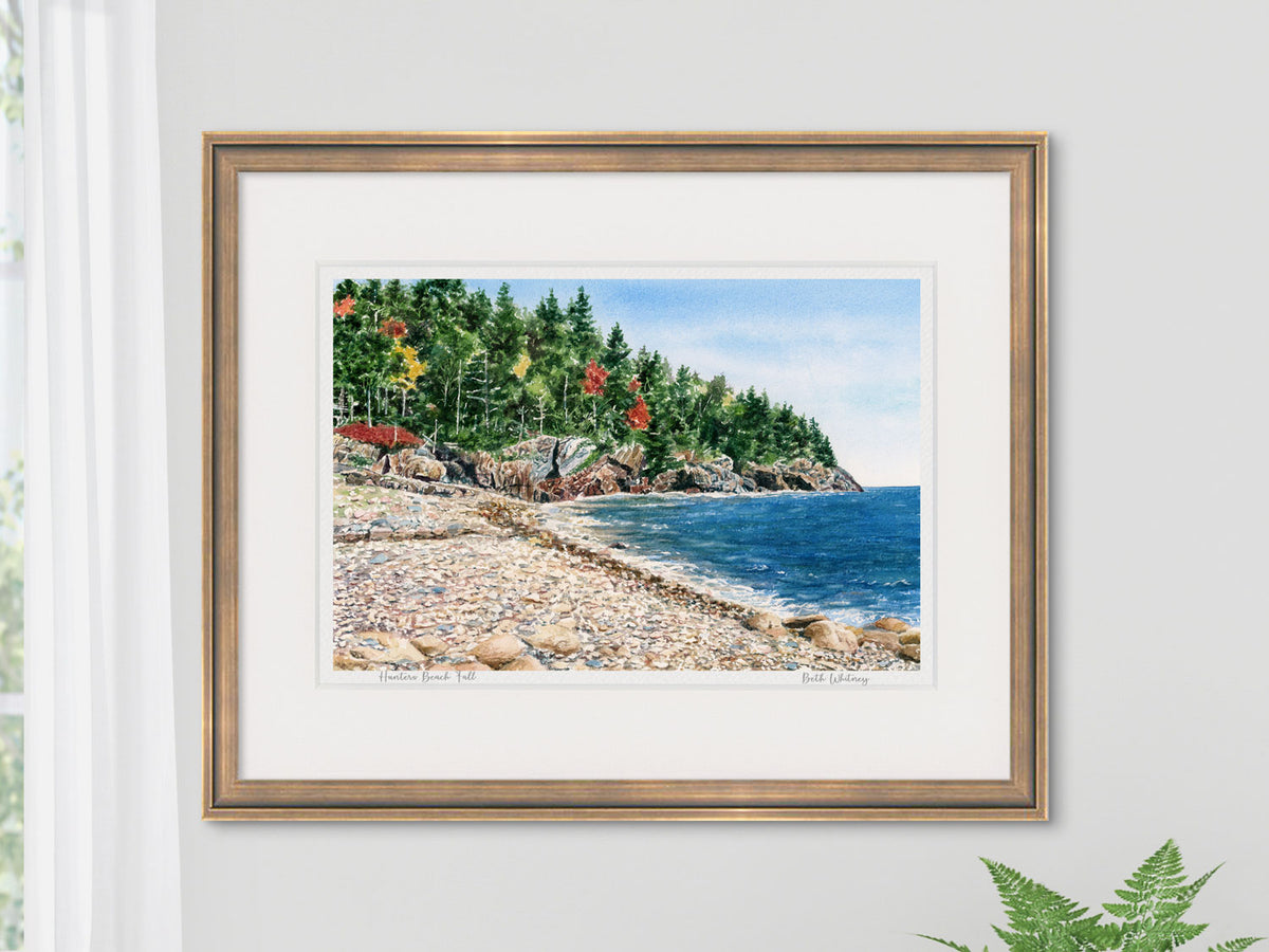 Framed watercolor print of Hunters Beach Fall, Acadia area, in a warm wood frame on a neutral wall.