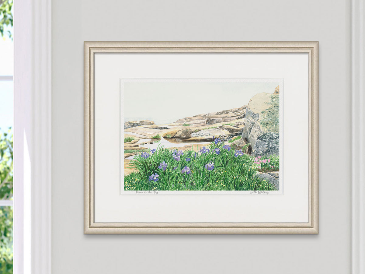 Framed watercolor print of Irises in the Fog, Schoodic Peninsula, in a light gold frame on a neutral wall.