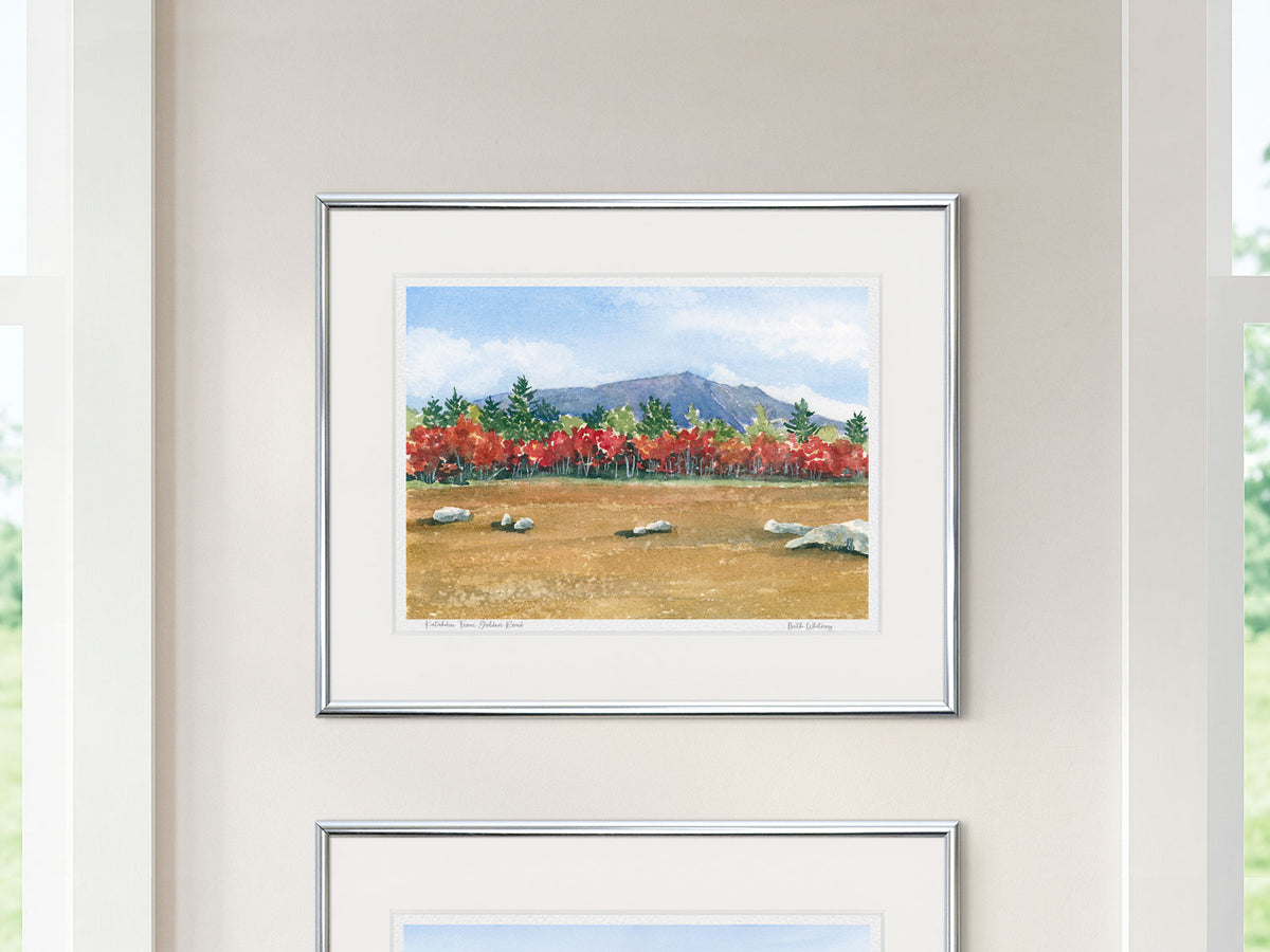 Framed watercolor print of Katahdin From the Golden Road, Maine, in a silver frame with natural window light.