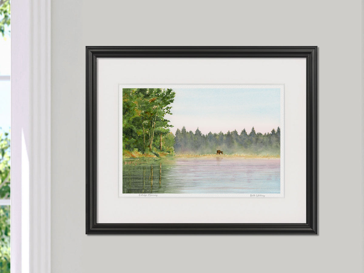 Framed watercolor print of Kokadjo Morning, Roach Pond, in a black frame on a neutral wall.