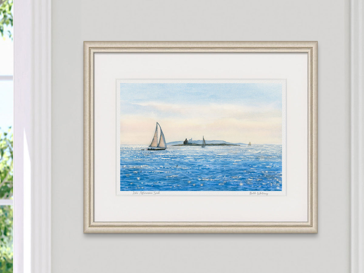 Framed watercolor print of Late Afternoon Sail, Ocean Point, Maine, in a soft gold frame with natural window light.