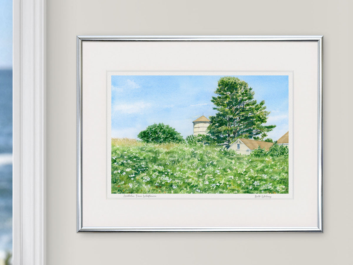 Framed watercolor print of Laudholm Farm Wildflowers in a silver frame with natural window light.