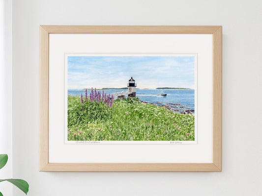 Framed watercolor print of Marshall Point Wildflowers, Port Clyde, Maine, in a warm wood frame on a neutral wall.