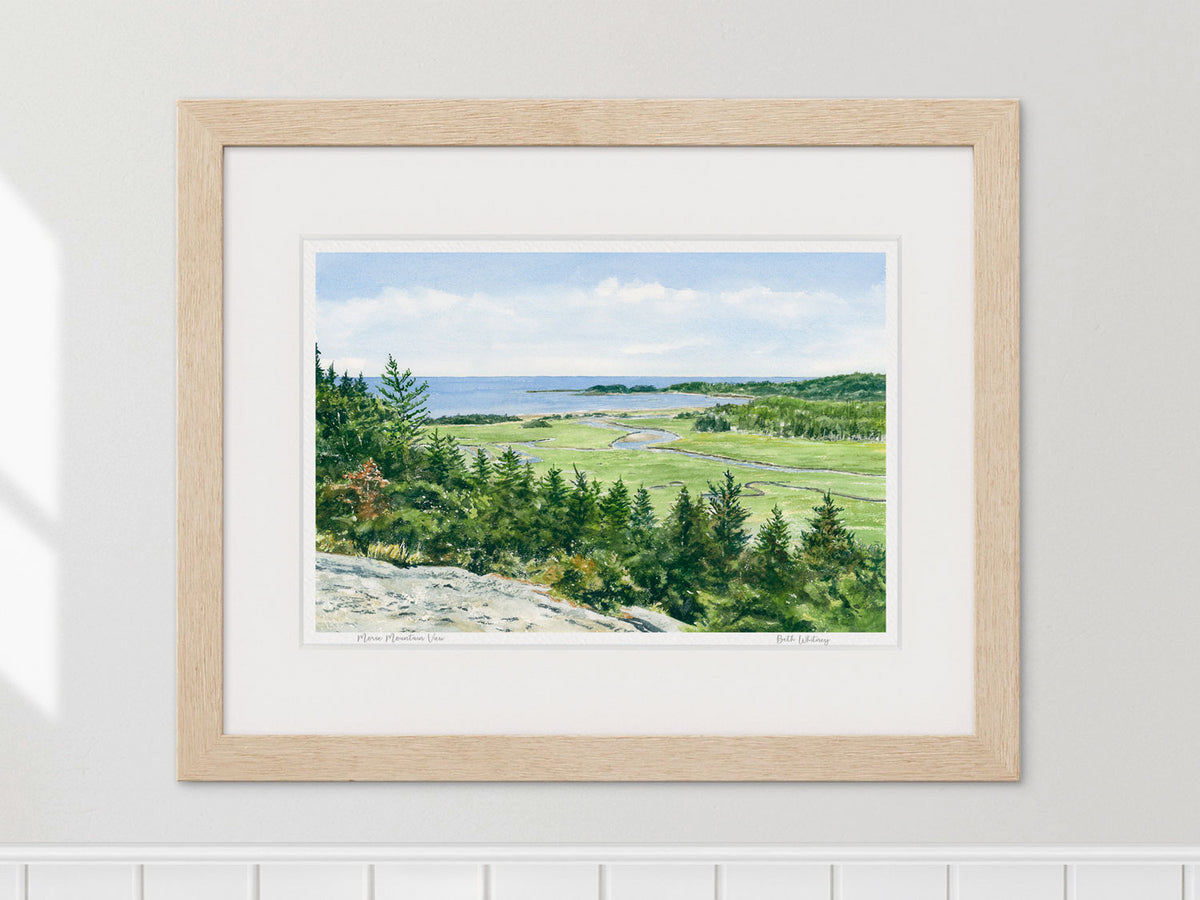 Framed watercolor print of Morse Mountain View, Phippsburg, Maine, in a warm wood frame on a neutral wall.
