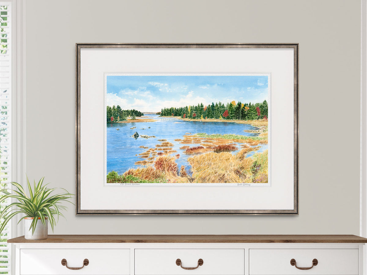 Framed watercolor print of Mt Desert Narrows, Mount Desert Island, in a warm wood frame on a dresser in a lifestyle setting.
