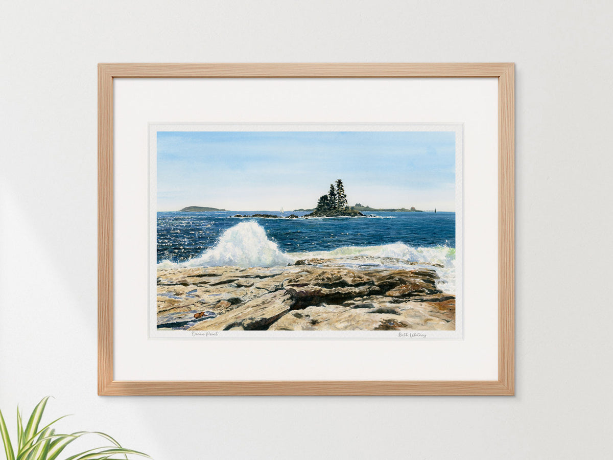 Framed watercolor print of Ocean Point, East Boothbay, Maine, in a warm wood frame on a neutral wall.