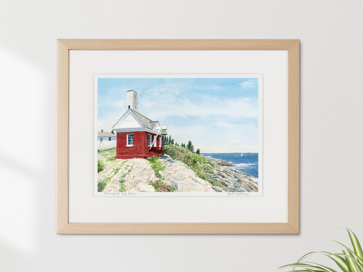 Framed watercolor print of Pemaquid Fog House, Pemaquid Point, Maine, in a warm wood frame on a neutral wall.