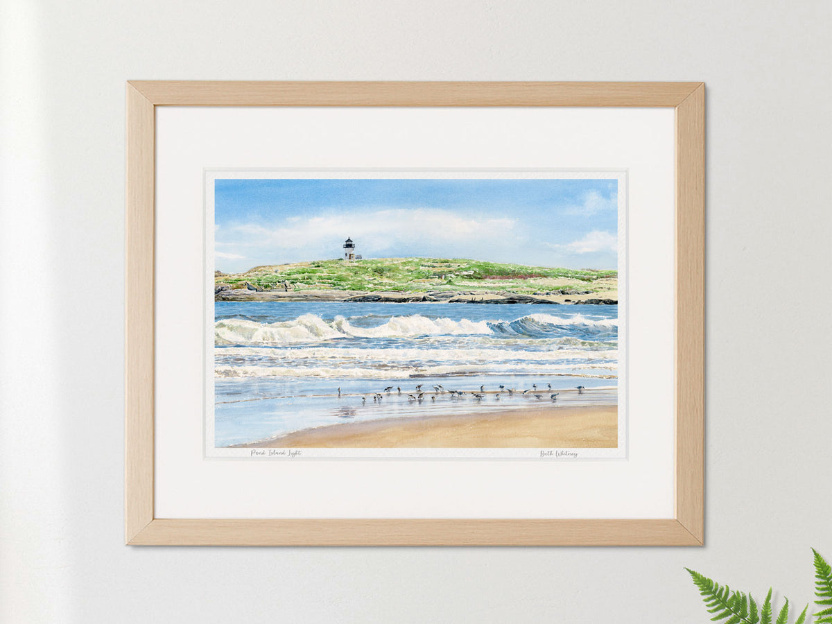 Framed watercolor print of Pond Island Light, Phippsburg, Maine, in a warm wood frame with plant styling.