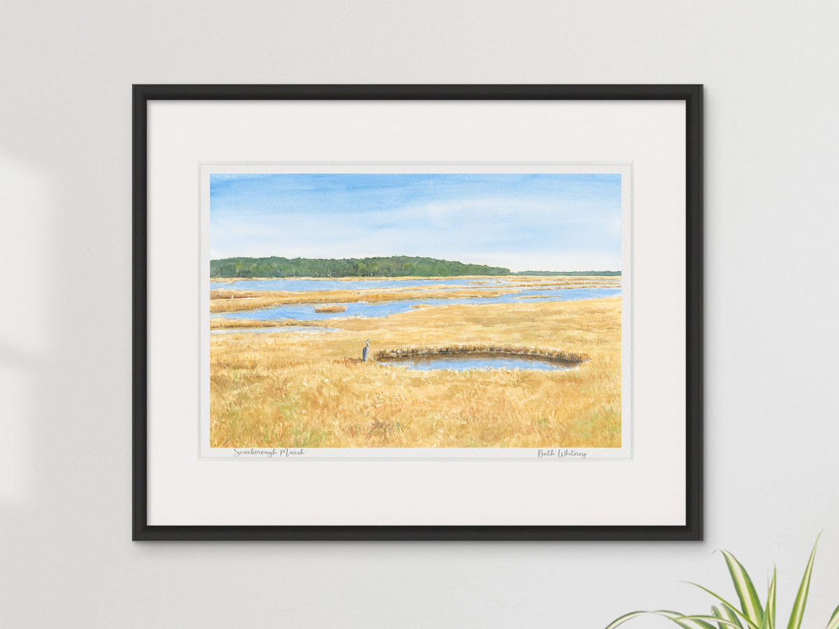 Framed watercolor print of Scarborough Marsh, Maine, in a contemporary black frame on a neutral wall.