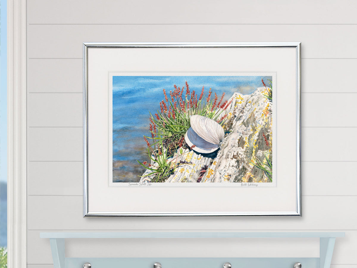 Framed watercolor print of Seaside Still Life, Orr's Island, Maine, in a silver frame in a coastal-inspired home decor.