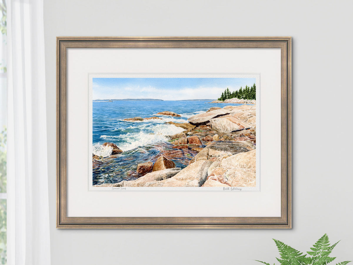 Framed watercolor print of Sunset Surf, East Penobscot Bay, Maine, in a gold frame on a neutral wall.