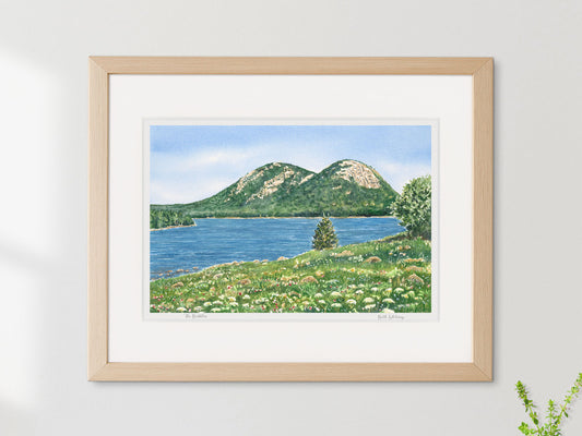 Framed watercolor print of The Bubbles, Jordan Pond, Acadia National Park, in a simple wood frame on a sunny wall.