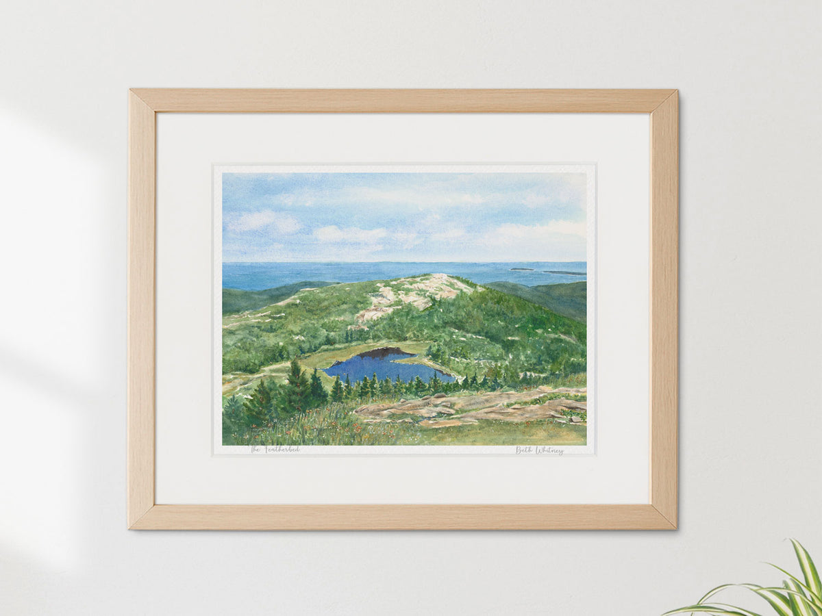 Framed watercolor print of The Featherbed, Cadillac Mountain, Acadia National Park, in a warm wood frame on a neutral wall.