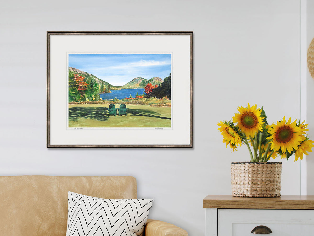 Framed watercolor print of The Invitation, Jordan Pond and The Bubbles, in a warm wood frame in a lifestyle setting.