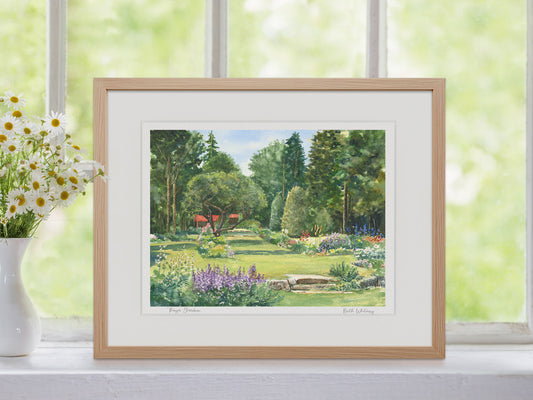 Framed watercolor print of Thuya Garden, Mount Desert Island, Maine, in a warm wood frame in a window setting with flowers.