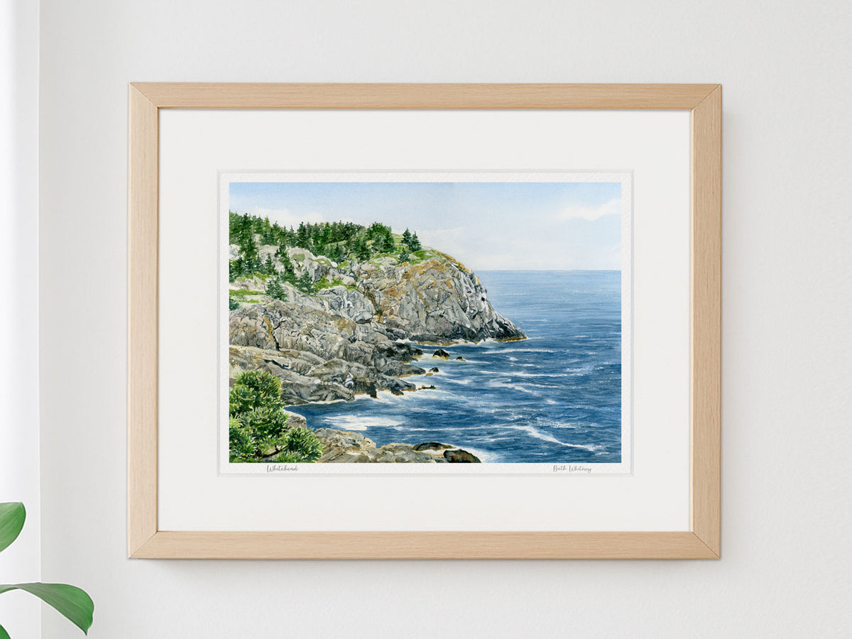Framed watercolor print of Whitehead, Monhegan Island, Maine, in a natural wood frame for a coastal wall decor.