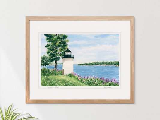 Framed watercolor print of Whitlocks Mill Light, Calais, Maine, in a warm wood frame on a neutral wall.