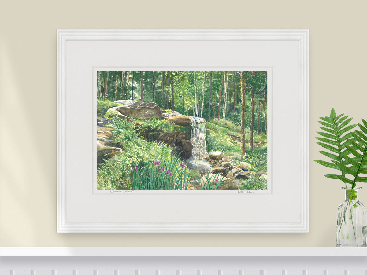 Framed watercolor print of Woodland Waterfall, Coastal Maine Botanical Gardens, in a white frame with fern styling.